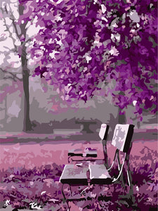 Empty seat under purple forest